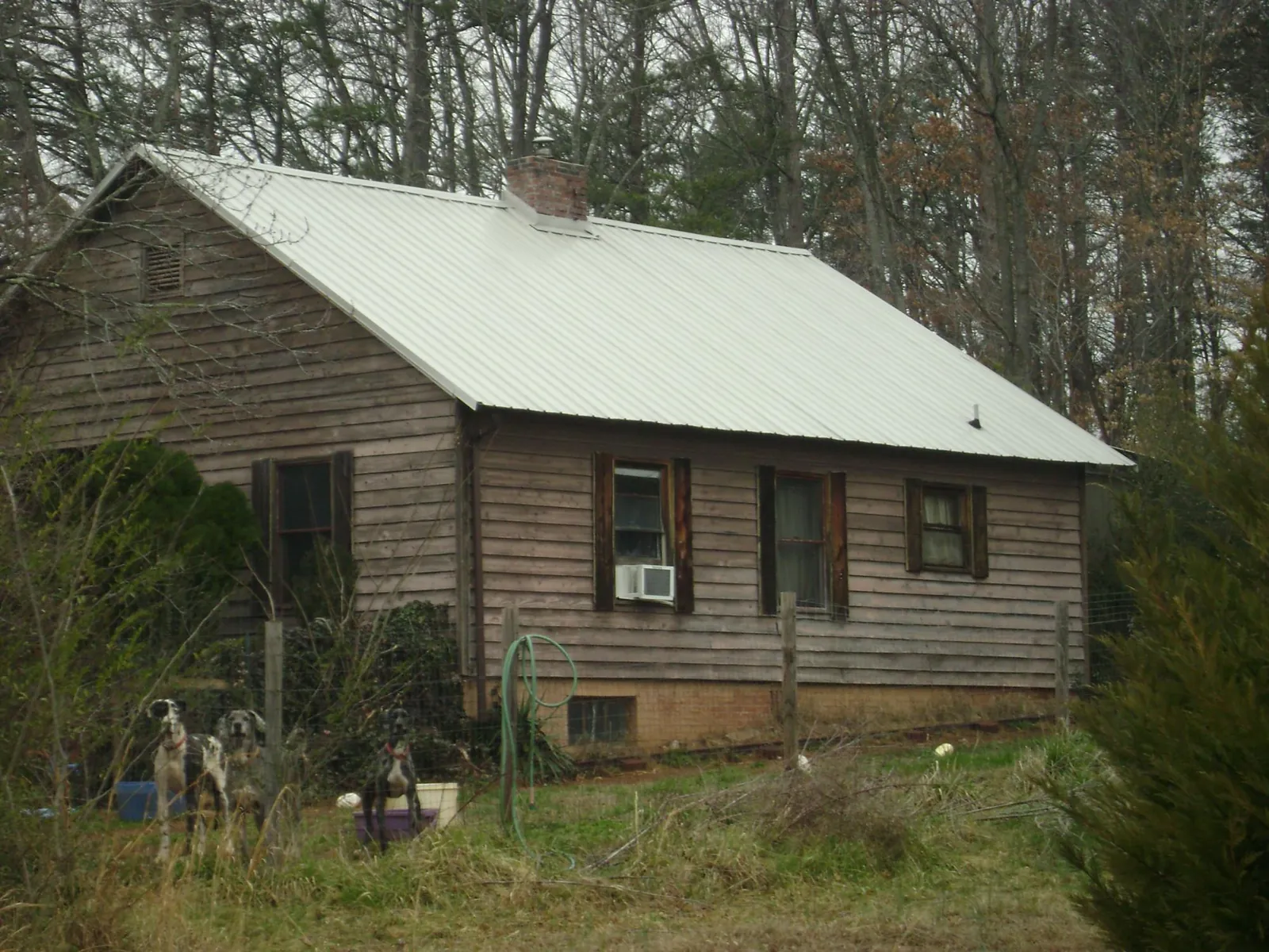 White metal roof on an old wood sided farmhouse, from a Metal Roof Installation job in Mountain Home Afb